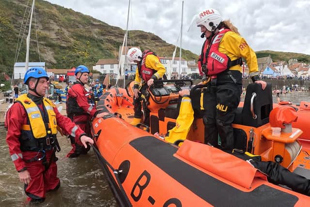 HM Coastguard officers and Staithes and Runswick RNLI volunteer crew during a demonstration rescue - Image: RNLI