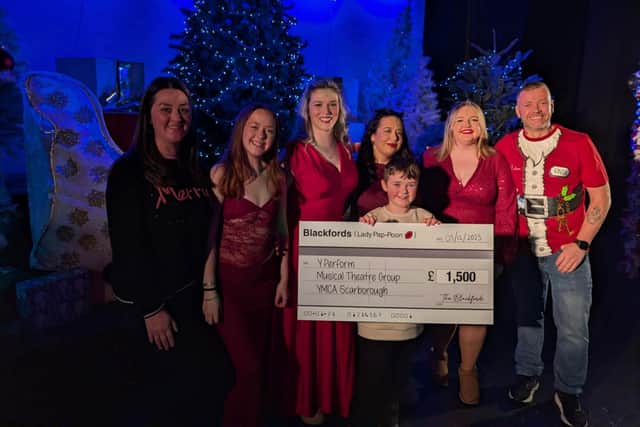 Steve Blackford handing over a cheque for £1,500 to the Y Perform musical theatre group in Scarborough.