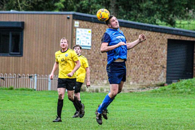 Edgehill Reserves head the ball clear.