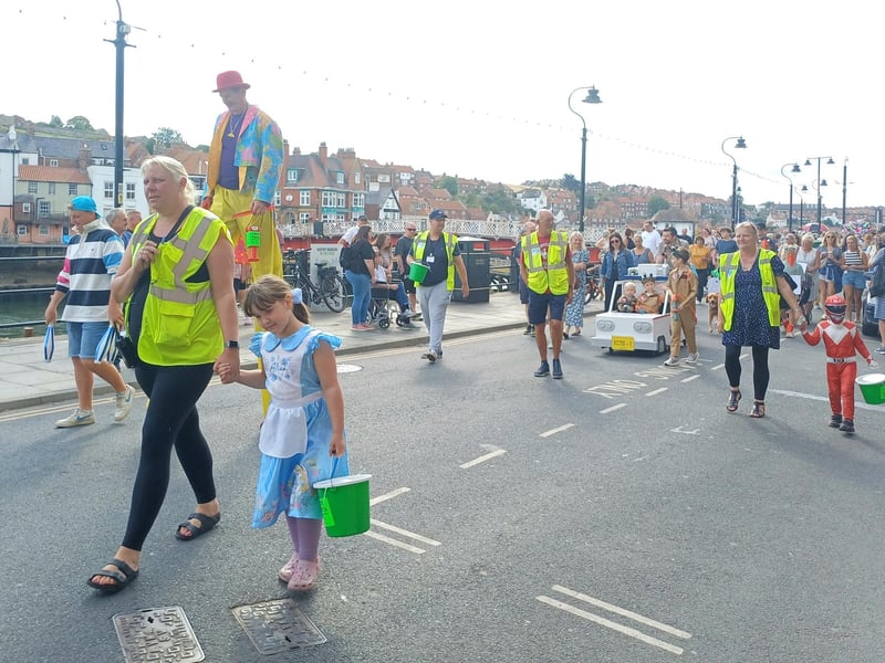 The walking parade makes its way along the harbourfront. photo: Emma Atkins