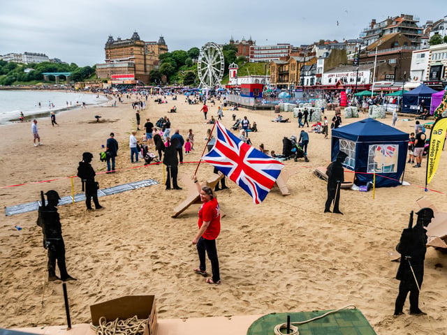 Dawen Dyson, from Animated Objects walks through the cardboard cut-outs representing the D-Day Landings made by over 150 community volunteers