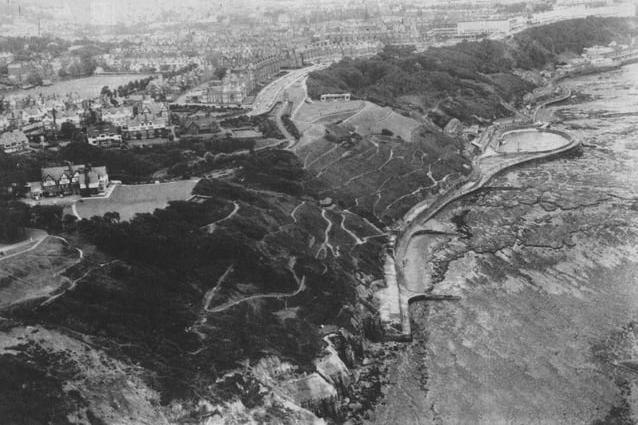 In this aerial shot, the hotel can be seen on the left before the landslide.
