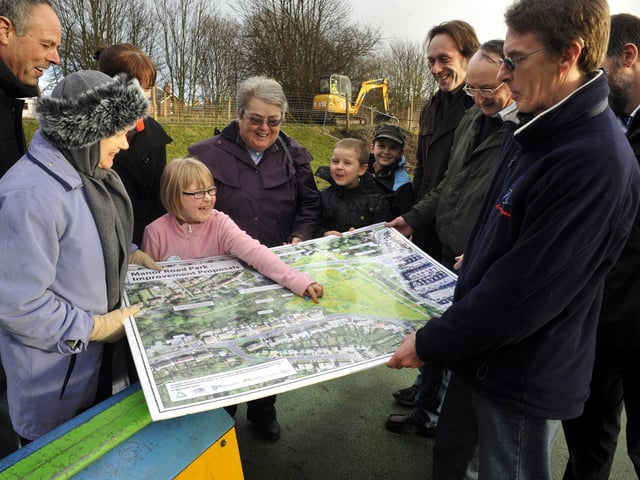Work on Manor Road Park play area improvements begin. A youngster points out the new play area on the plans to some members of the Friends of Manor Road Park.