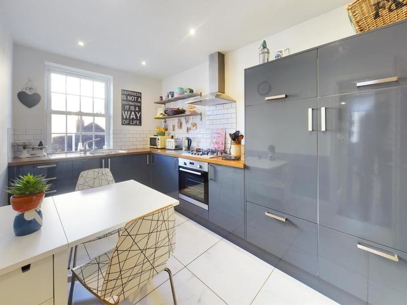 The dining kitchen has fitted units, an electric oven, gas hob, and integrated fridge freezer. There's also a utility room.