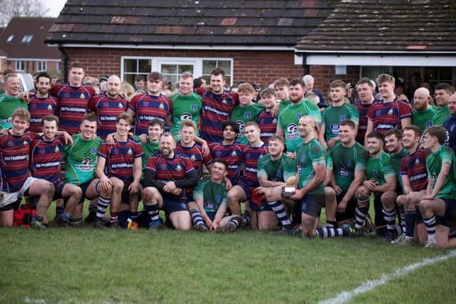 Captain Joe Holbrough holds the Bottomley Trophy after Pocklington's (green shirts) win over Old Pocklingtonians on Boxing Day.    PHOTO BY BECKY BRETT
