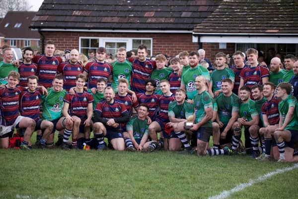 Captain Joe Holbrough holds the Bottomley Trophy after Pocklington's (green shirts) win over Old Pocklingtonians on Boxing Day.    PHOTO BY BECKY BRETT