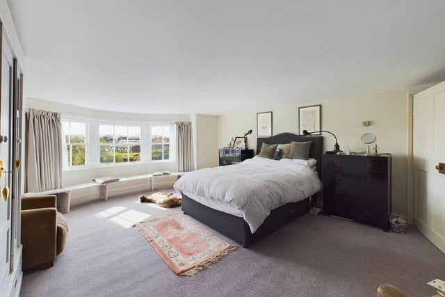 A bedroom with wide bay window attracts plenty of natural light.