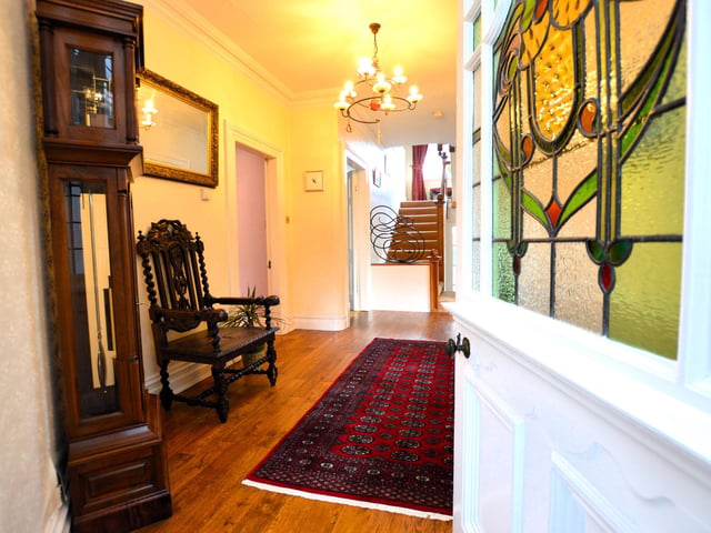 Entering the house to a spacious hallway that branches off to ground floor rooms.