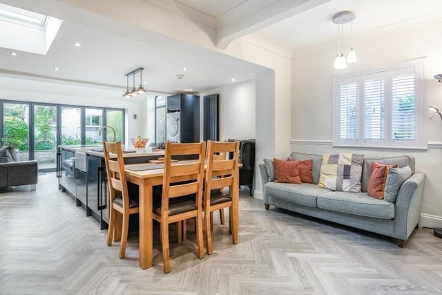 The open plan kitchen with living and dining area has bi-fold doors to the garden.
