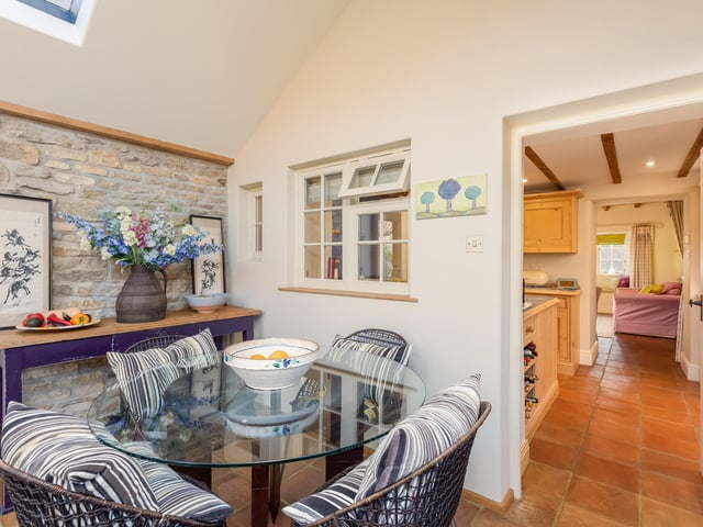 The dining room has doors that open to the courtyard garden at the rear.