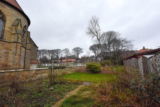 The enclosed garden of the bungalow stretches along the side of the church in this lovely spot in Robin Hood's Bay. Contact Henderson Property Services on 01947 602626.