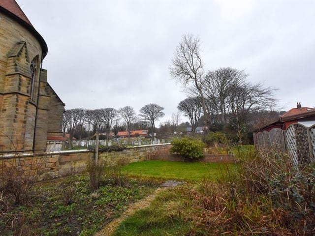 The enclosed garden of the bungalow stretches along the side of the church in this lovely spot in Robin Hood's Bay. Contact Henderson Property Services on 01947 602626.