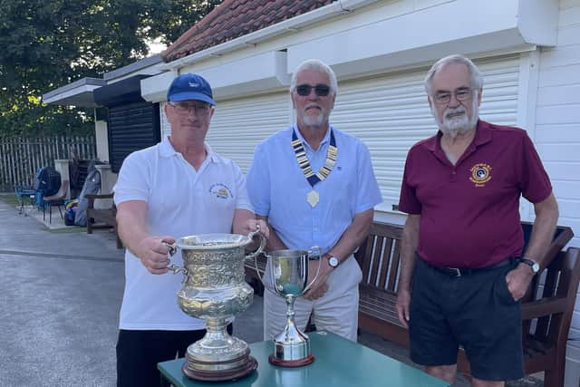 Picture shows first time winner Paul Morgan being presented with the 100 year old trophy by East Coast President Pete Charter whilst East Coast fixture secretary David Muir, who ran the competition looks on