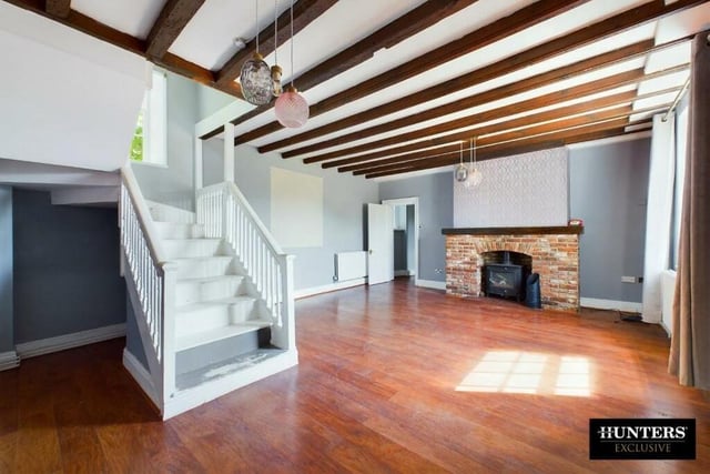 The lovely interior features beamed rooms with rustic fireplaces.