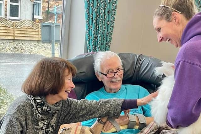 Resident Brian and his wife Hazel enjoy meeting Orion the Angora rabnbit.