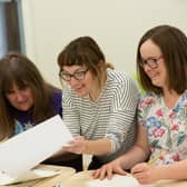 Artist Dawn Brooks (centre) hosting a workshop with Mencap participants Yammy Lighjani (left) and Zoe Knight (right).