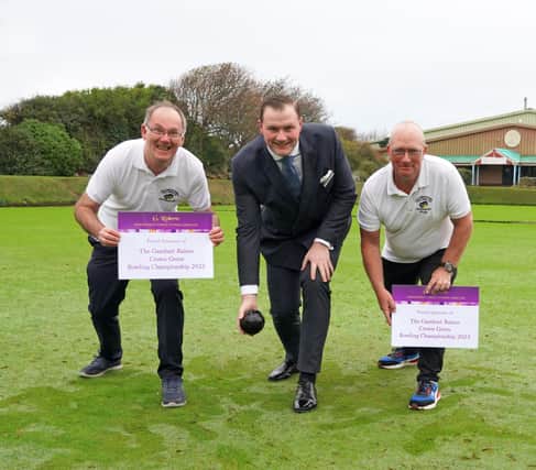 Local bowls stars Robert Child, left, and Paul Morgan, right, with the tournament's sponsor George Roberts in the middle