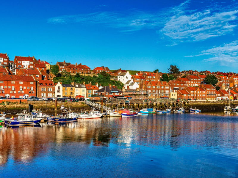 Boats in a sunny Whitby harbour, by Brian Murfield.