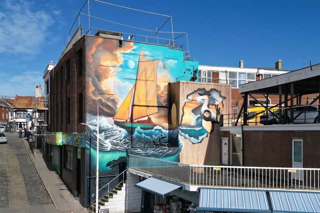 The Great Gale mural – the infamous sea tragedy of 1871 – alongside gannets, a puffin and a lobster, painted on the side of the G.O.A.T bar.