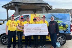 The Whitby Boxing Day dippers present a cheque to Yorkshire Air Ambulance.