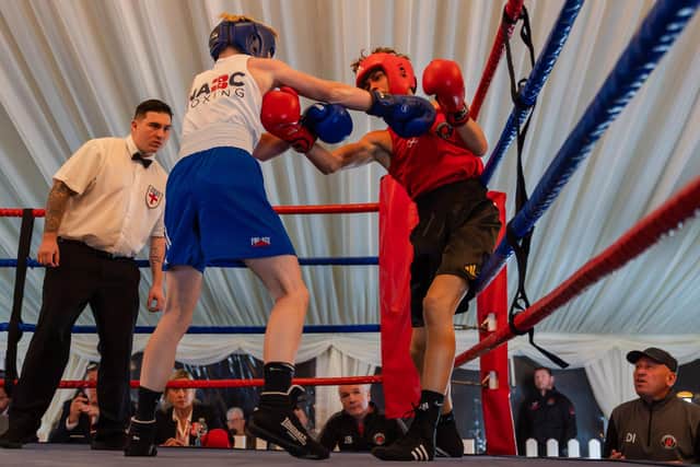 Scarborough ABC boxer Spencer Taylor (red vest) in action. Photo by Wandering Photography
