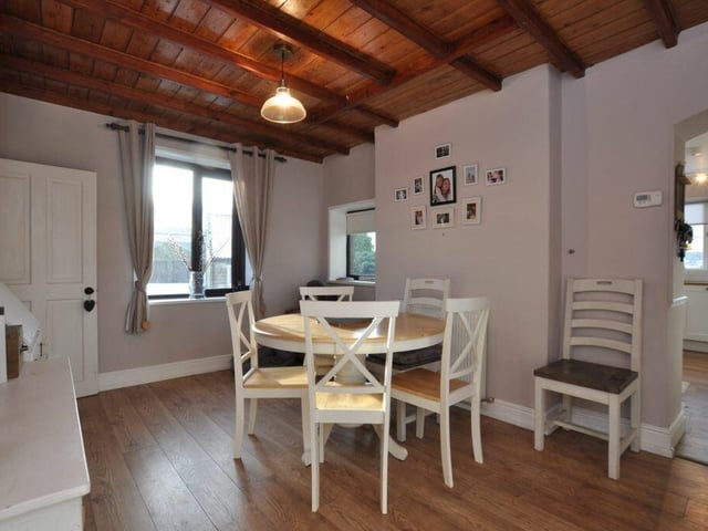 Versatile beamed space currently used as a dining area.