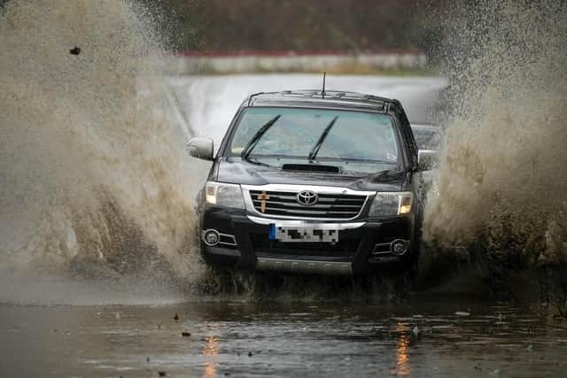 Motorists tackle a flooded road. (Pic credit: Christopher Furlong / Getty Images)