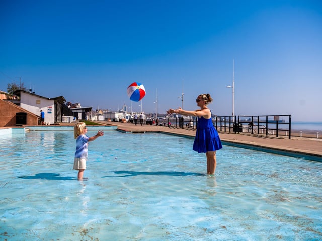 Laura Doyle, from Bradford, West Yorkshire, plays ball with her son River, aged 4, whilst cooling off in the childrens paddling pool along the Princess Mary Promenade.