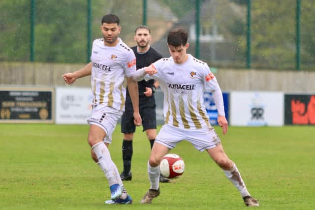 Bridlington Town earned a crucial 2-0 win at Grimsby Borough to seal their NPL East Division survival.