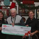 Nicky Healy (on right)  and Linda Clelland, owner of the Ship,  presenting Brian Stephenson (Muston in Bloom chairman) with a cheque for the £1233.50