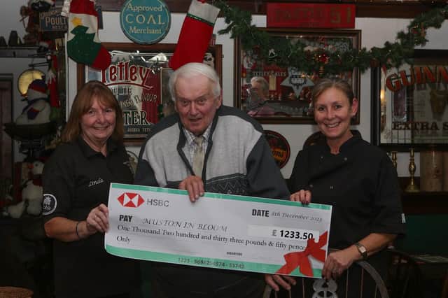 Nicky Healy (on right)  and Linda Clelland, owner of the Ship,  presenting Brian Stephenson (Muston in Bloom chairman) with a cheque for the £1233.50