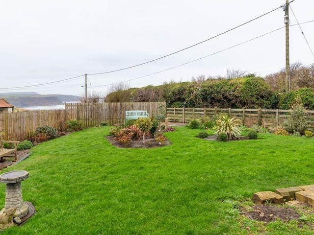 A lawned and enclosed garden with sea views.