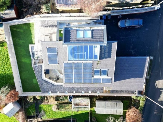 Looking directly over the four-bedroom hilltop property and its gardens.