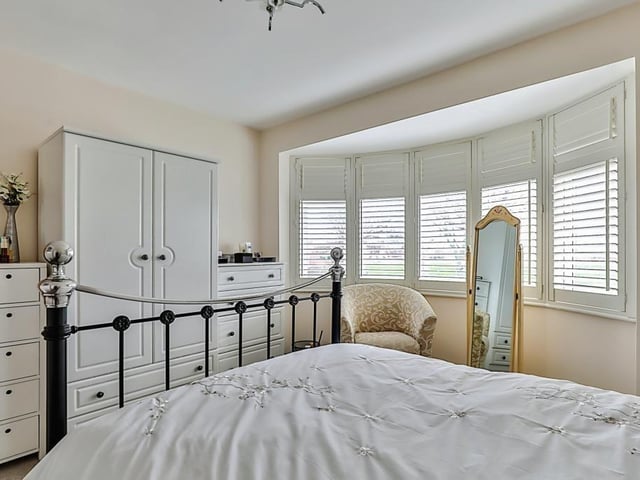 A double bedroom with a feature bay window.