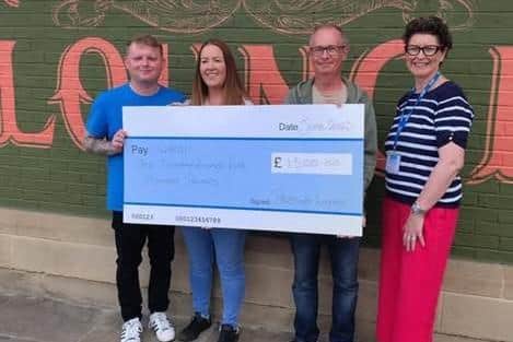 WHISH chairman Steve Bremner and Samantha receiving the cheque from Claire and Danny of Whitby’s Pescado Lounge.