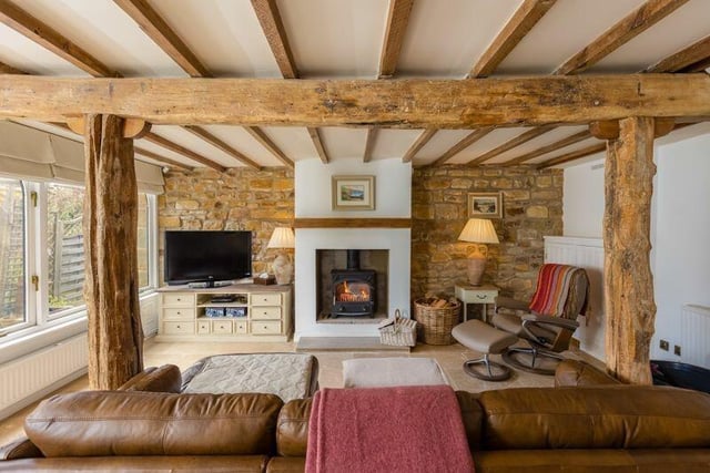An open plan living room with wood burning stove.