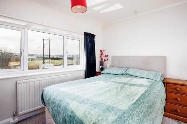 One of the bedrooms, with far reaching views from the window. There are two double bedrooms and a single bedroom with this property,  with a further bedroom or office area available in the loft.
