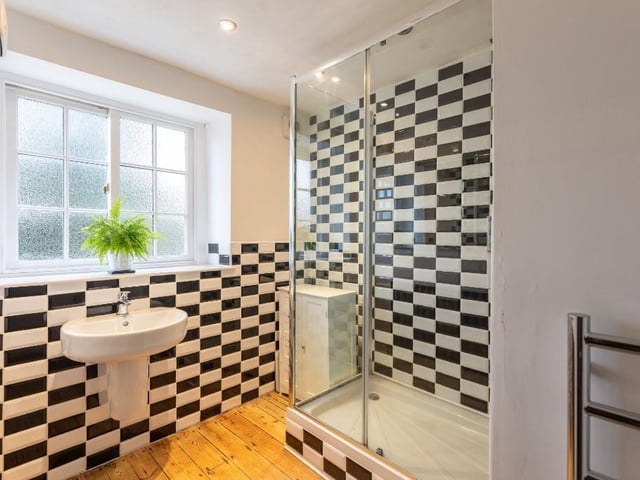 The tiled ground floor shower room in the cottage.