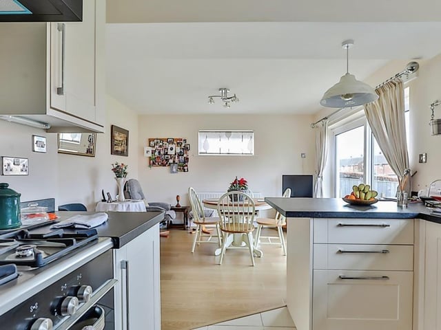 The open plan kitchen through to diner, with doors out to a patio.