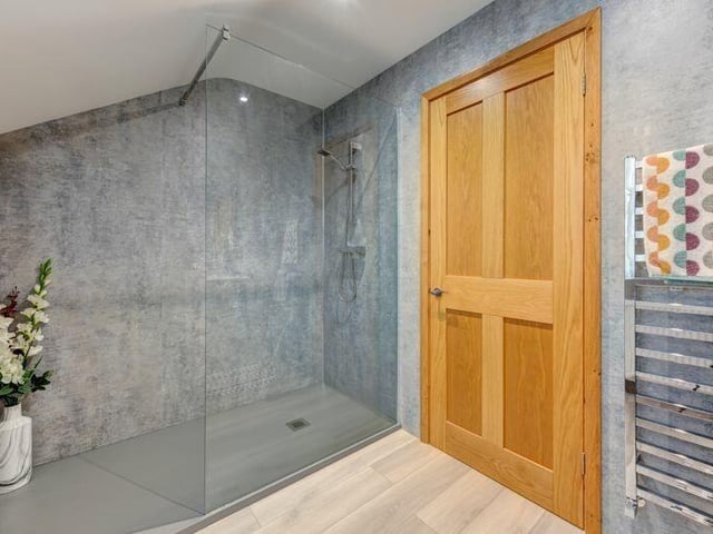A bathroom with walk-in shower.