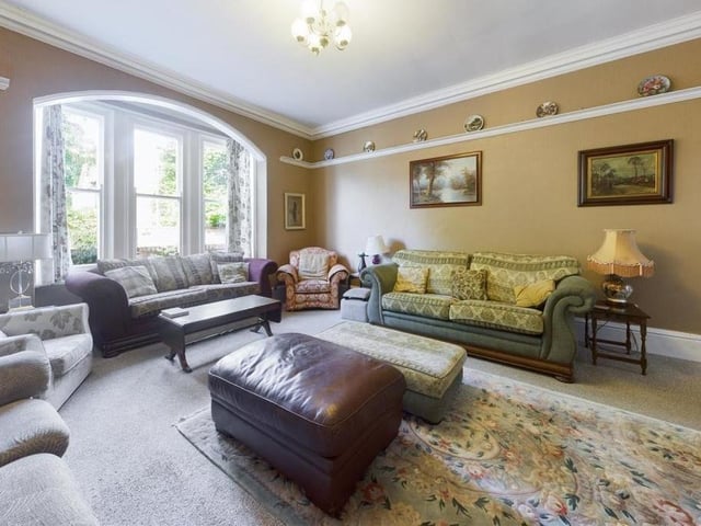 A feature bay window allows natural light to flood in to this elegant lounge with picture rail.