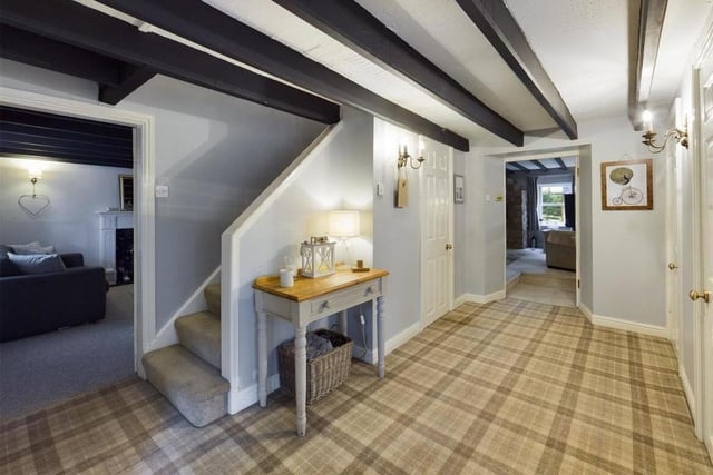 A welcoming hallway with ceiling beams, that are a feature throughout ground floor rooms.