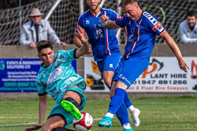 Aaron Haswell has a shot blocked by a Bishop Auckland player