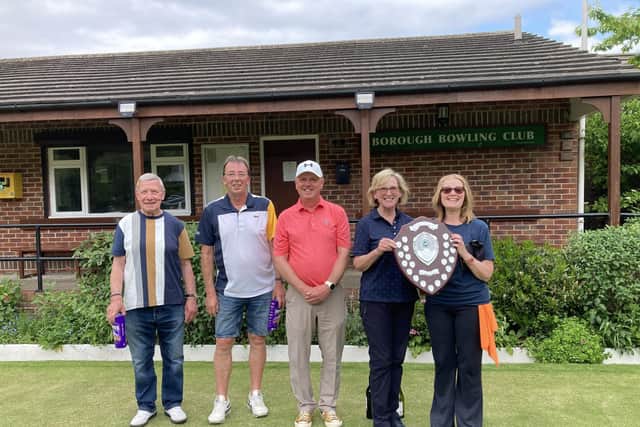 Borough Bowling Club secretary Barrie Watson presents the prizes to the winners.