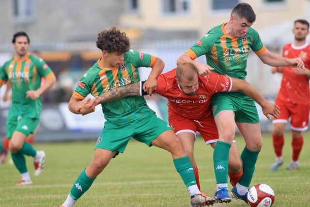 Ashington get to grips with Town forward Jake Day. Photo by TCF Photography