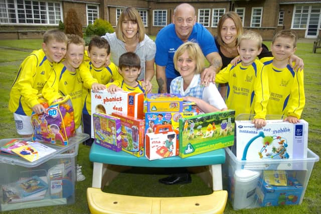 Scarborough children's ward playworker Tracey Cleminson, front, is pictured with some of the toys presented by Phoenix FC.
