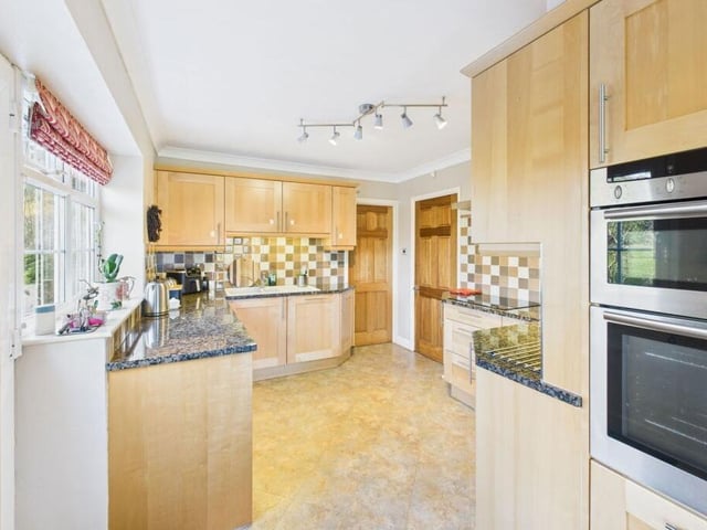 The kitchen, with its full range of matching units, leads to a breakfast area.