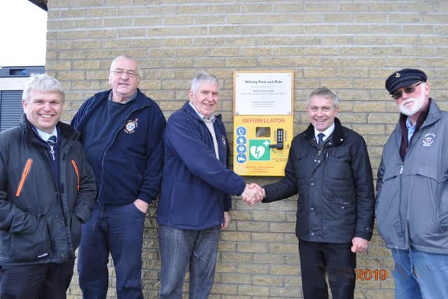 From left to right: Chris Roe, Alf Abbott, Bob Stevens, MP Sir Robert Goodwill and Bob Bennett with the Whitby park and ride defibrillator.