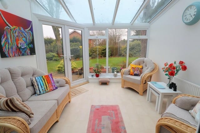 A sunny conservatory has doors out to the rear garden.