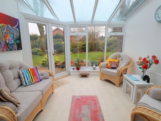 A sunny conservatory has doors out to the rear garden.